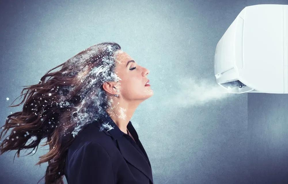 a person spraying air conditioner