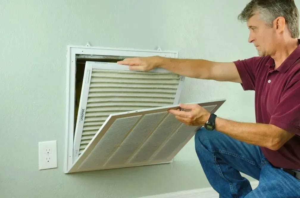 a person opening a vent