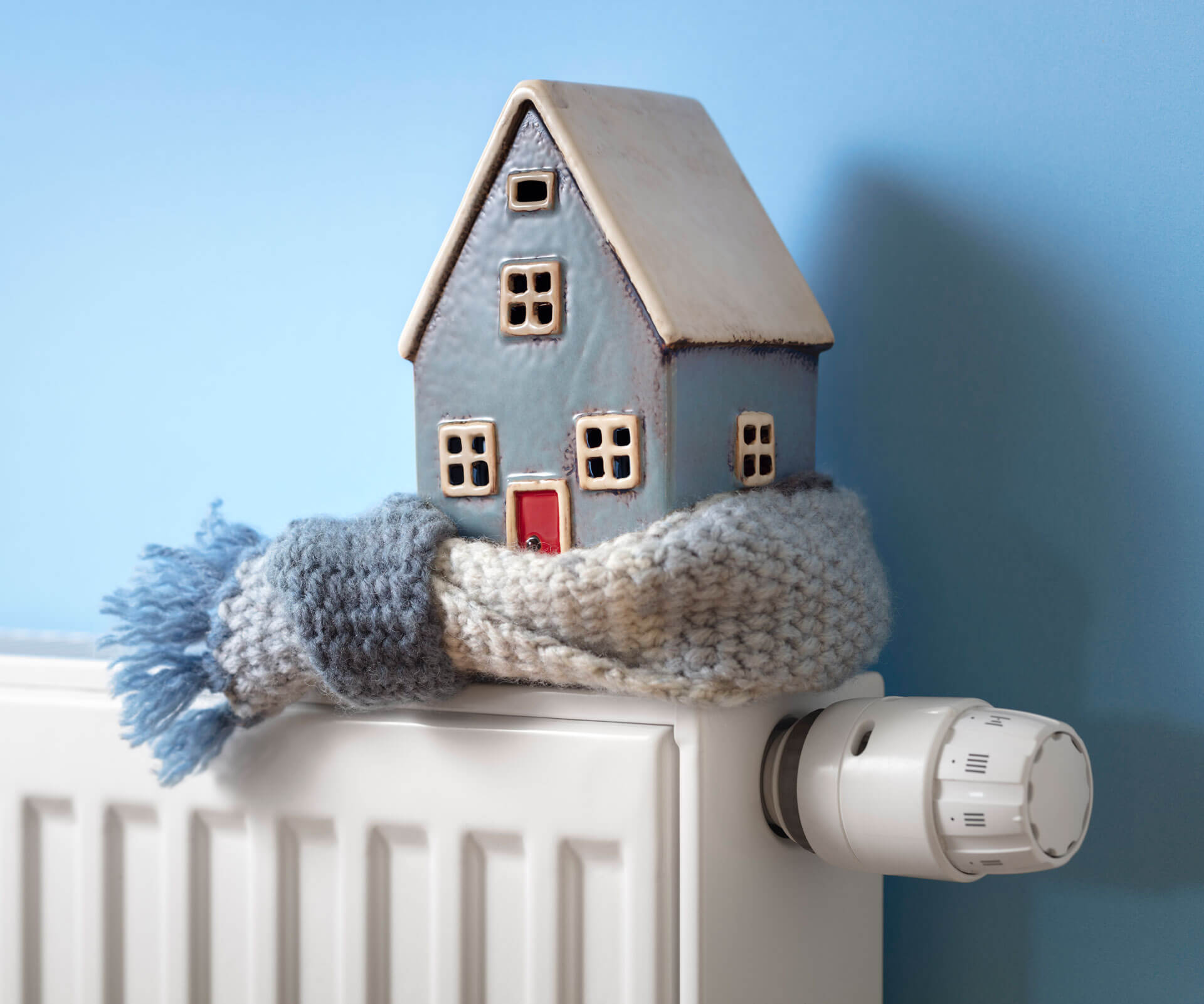 House model wrapped in scarf on radiator