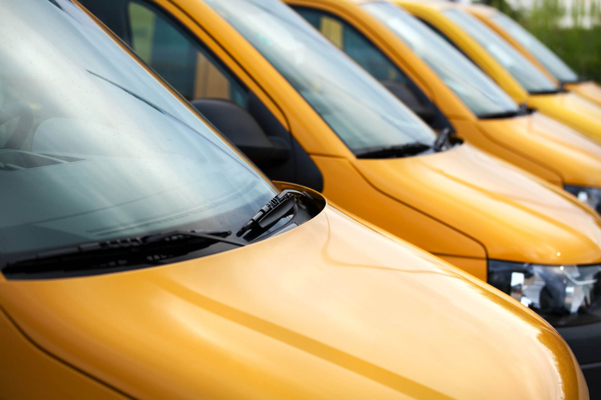 up close view of a fleet of yellow vans