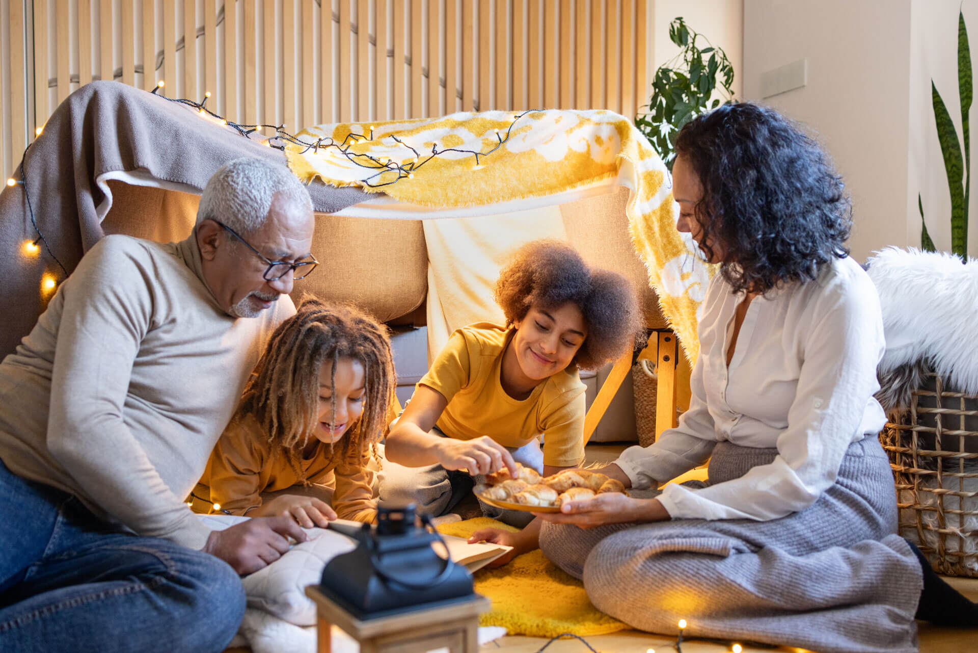 Grandparents and grandchildren enjoying a moment in a blanket fort