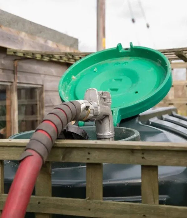 Home oil tank being refueled