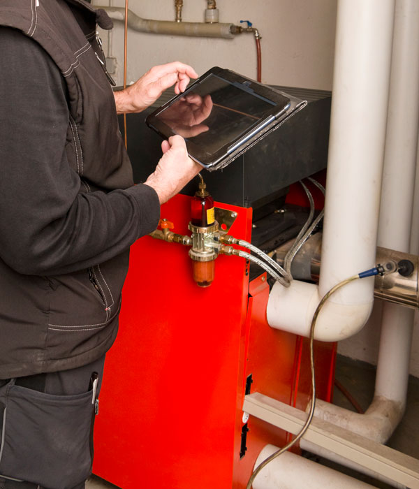 Technician checking an oil heating system